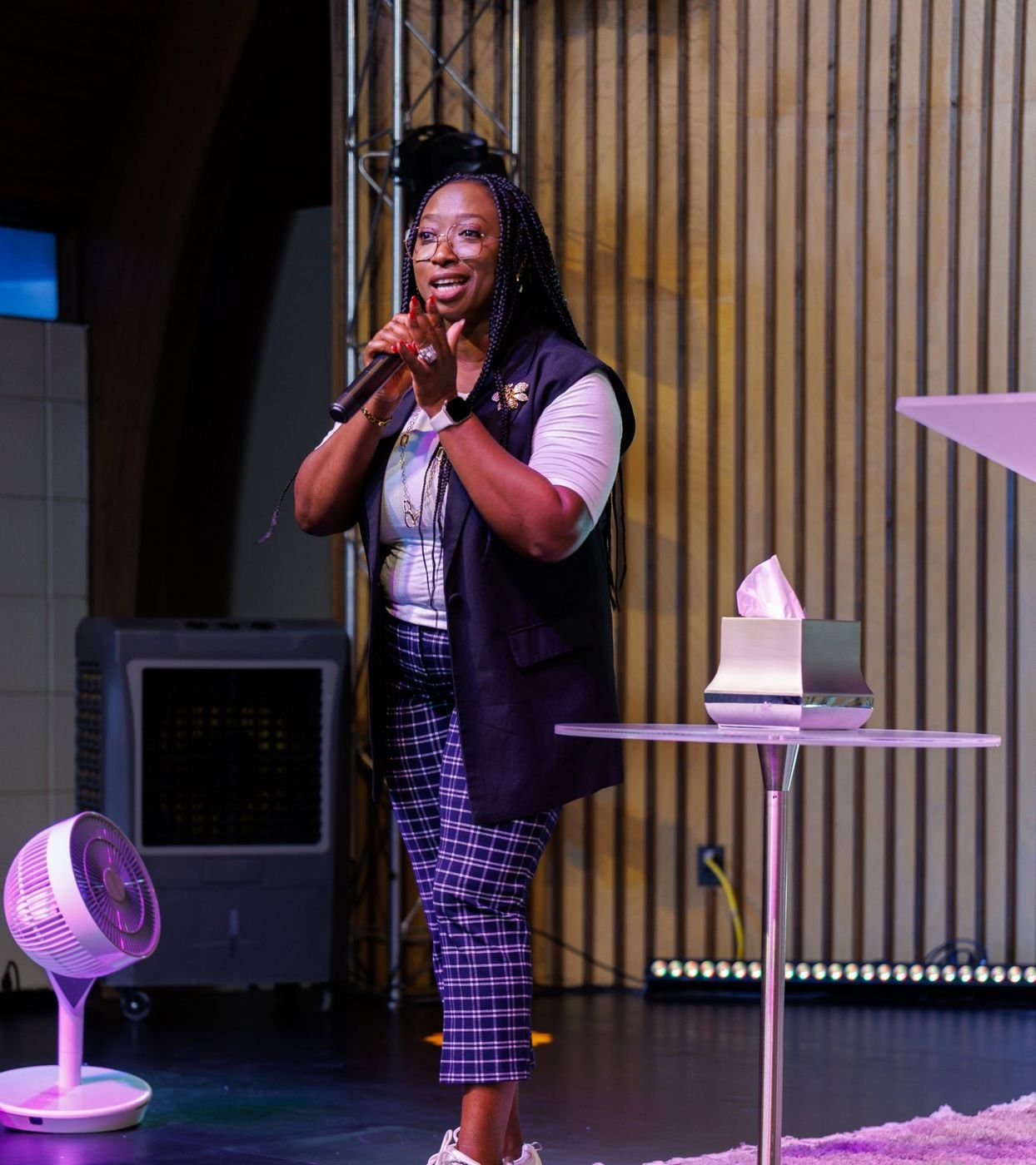 Kemi speaking energetically on stage